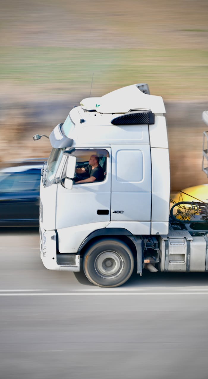 Dynamic shot of a white truck speeding on a highway in Agramunt, Spain.