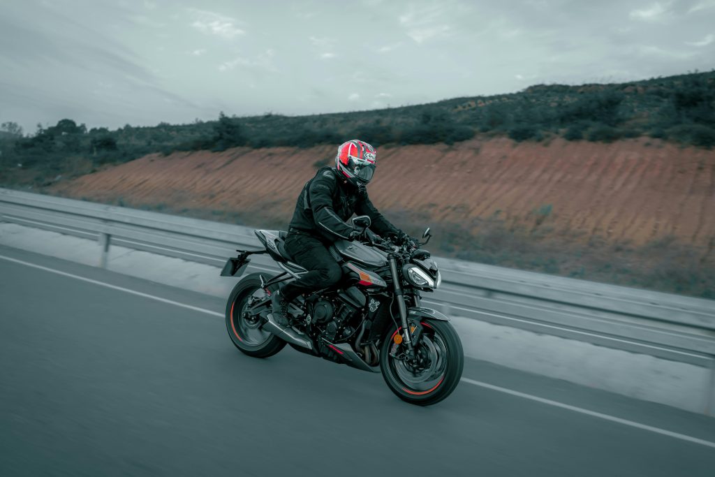 pexels photo 28886564 28886564 A biker on a black motorcycle cruising along an open highway, showcasing speed and freedom.
