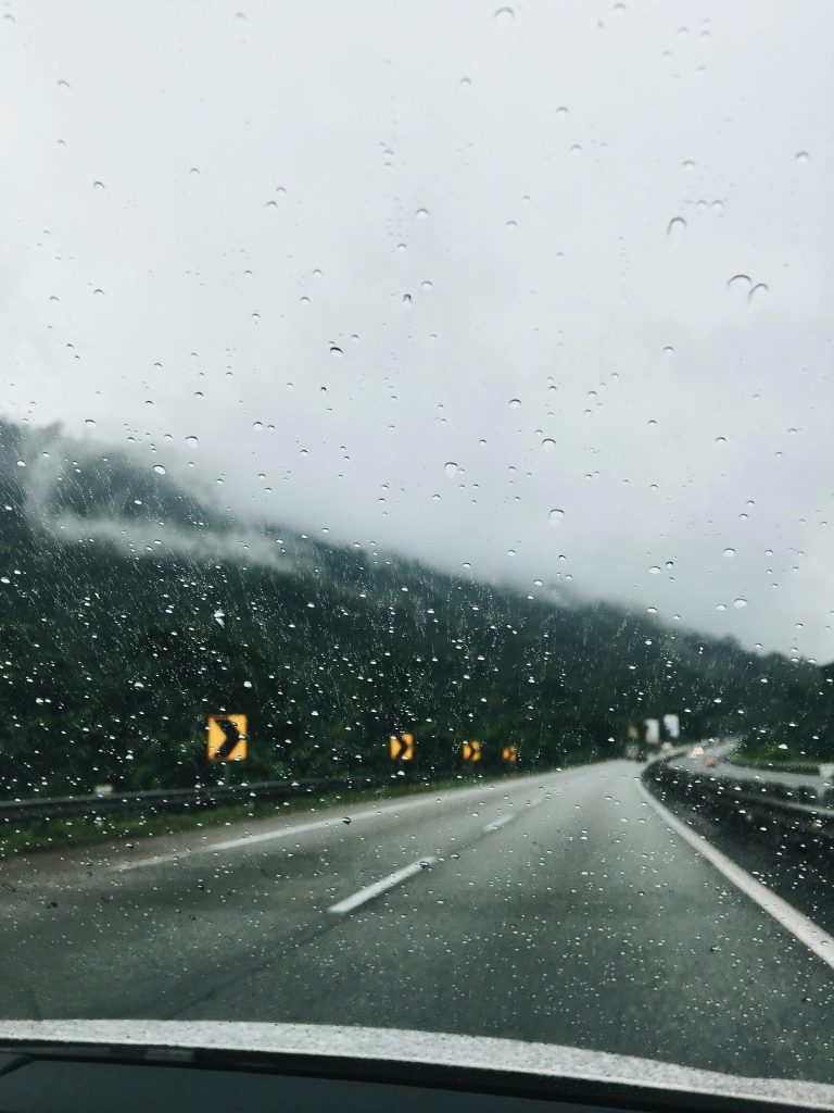 Experience a rainy drive on a winding highway in Seri Kembangan, Malaysia.